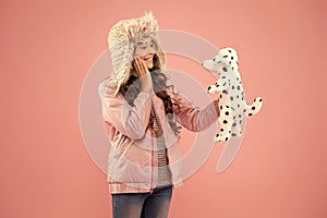 Pleasant thoughts. autumn style. Childhood happiness. happy kid pink background. little girl dalmatian dog toy. cold
