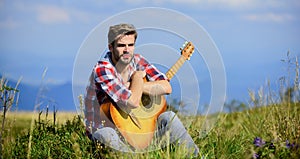 Pleasant time alone. Musician looking for inspiration. Dreamy wanderer. Peaceful mood. Guy with guitar contemplate