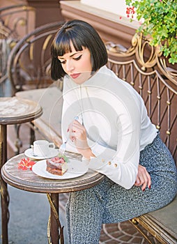 Pleasant time and relaxation. Gourmet concept. Delicious gourmet cake. Woman attractive brunette eat gourmet cake cafe