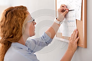 Pleasant woman holding the calendar