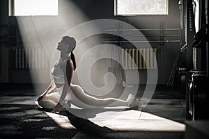 Pleasant Woman Stretch Legs to Sit in Twine . photo