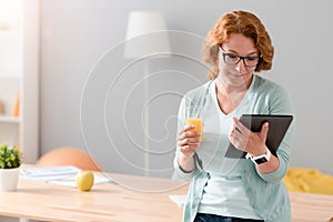 Pleasant woman using tablet