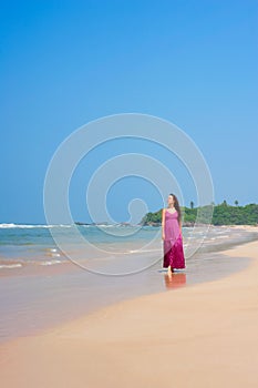 Pleasant woman walking at the beach