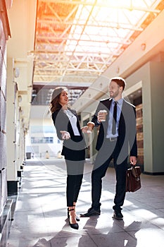 Pleasant young employees laughing at opponents, competitors