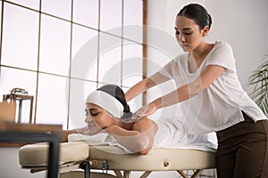 Pleasant young woman doing a professional massage