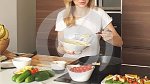 Pleasant young woman preparing dinner in a kitchen concept cooking.