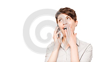 Pleasantly shocked woman with mobile phone on a white photo