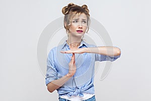 Please break! Time out, stop sign. Young adult blonde girl showing warning sign.