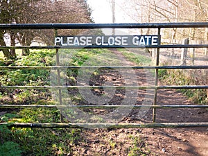 please close gate sign on metal closed gate outside country way