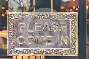 Please come in vintage sign in the store. Asia.