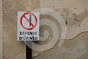 A please do not urinate sign in a small street in France photo
