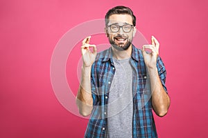 Please help me! Bearded young man need a help. Isolated on pink background, studio shot