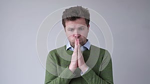 Please help me now. Bearded mature man need a help. Isolated on gray background, studio shot