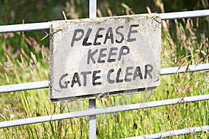Please keep gate clear sign in metal gate fence
