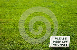 Please keep of the grass lettering sign on green background