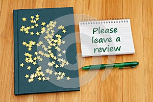 Please leave a book review with retro old blue book on a desk with stars