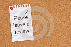 Please leave a review on ruled paper on a corkboard