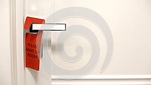 Please make up room red sign hanging on doorknob , hotel cleaning services