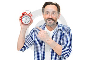 Please observe time. Mature man pointing finger at alarm clock. Mature timekeeper with analog clock. Bearded senior man photo