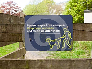 Please respect out campus keep dogs on leads and clean up after them sign