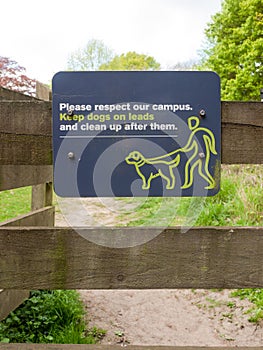 Please respect out campus keep dogs on leads and clean up after them sign