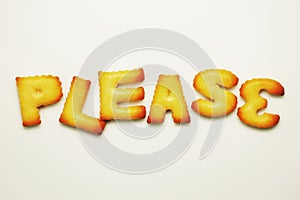 please word from alphabet biscuits on white background