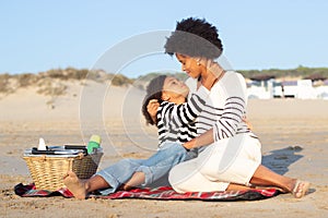 Pleased African American family on picnic on beach