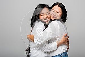 pleased asian mother and daughter in