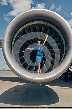 Pleased barefoot stewardess in uniform looking ahead