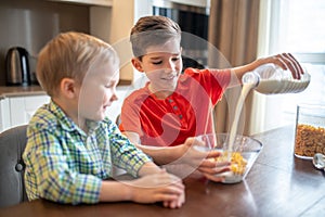 Pleased boy preparing a cold oatmeal dish for breakfast