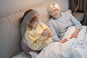 Pleased grandmother having a good time with her granddaughter