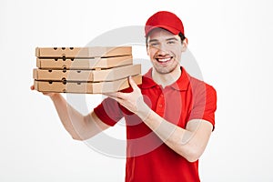Pleased guy dealer in red t-shirt and cap working in delivery se