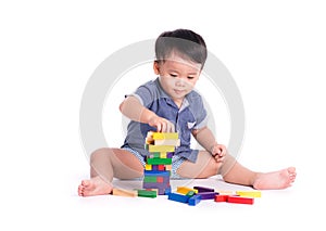 Pleased kid playing toy blocks isolated