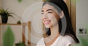 Pleased korean woman smiling at home