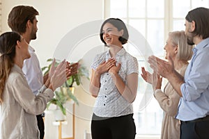 Pleased proud asian young businesswoman get team appreciation support applause photo