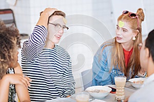 Pleased teenager spending pause with his friends