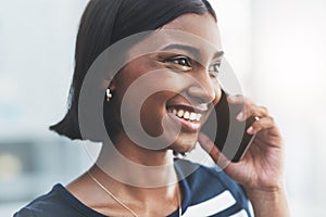 Pleased to have come to an agreement with you. Close up shot of a young businesswoman making phone calls in her office.