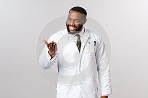 Pleased to meet you, tell me your problem. Portrait of polite and friendly, charismatic african-american doctor inviting