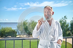 Pleased vacationer drinking a glass of water