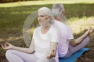 Pleased woman meditating with her husband stock photo