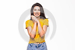 Pleased woman reclines on her hands and looking at the camera over white background