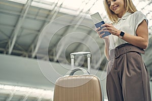 Close up of pretty woman looking at boarding pass