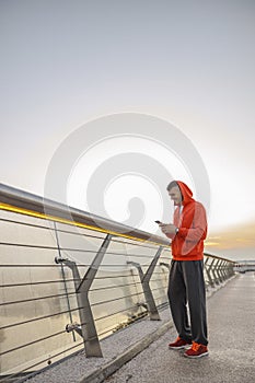 Pleased young man looking at his smartphone