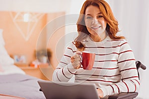 Pleased young woman working at home