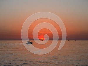 Pleasure boat against the backdrop of a beautiful sea sunset