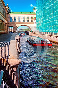 Pleasure boat floats on the Winter Canal in St. Petersburg