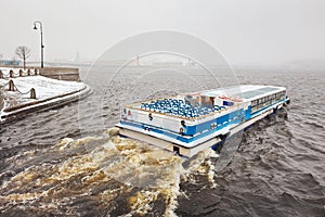 Pleasure boat on the Neva river in a spring snowstorm. St. Petersburg