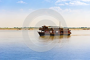 Pleasure boat on the river Irravarddy, Mandalay, Myanmar, Burma. Copy space for text.