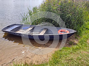 Pleasure boat on the shore of a calm lake