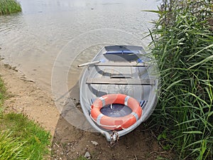 Pleasure boat on the shore of a calm lake